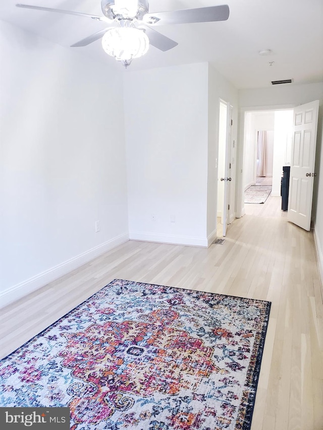 spare room featuring hardwood / wood-style flooring and ceiling fan