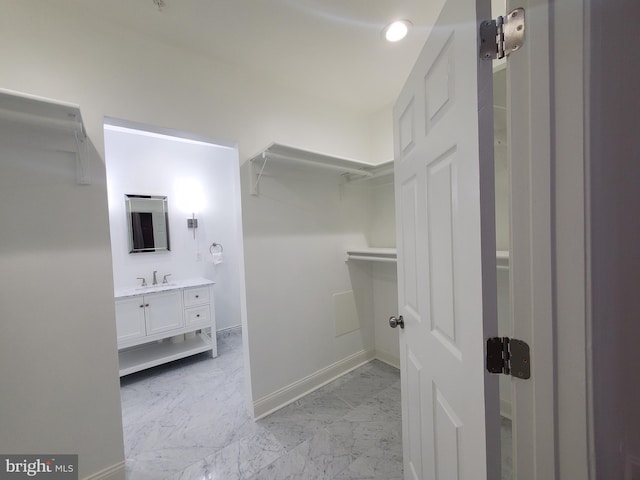 spacious closet featuring sink