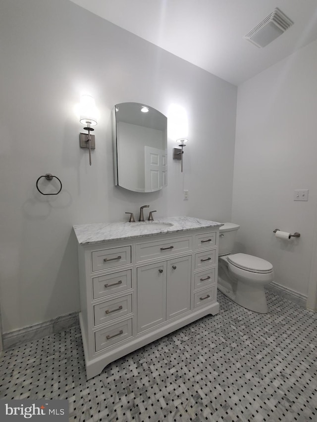 bathroom featuring toilet and vanity