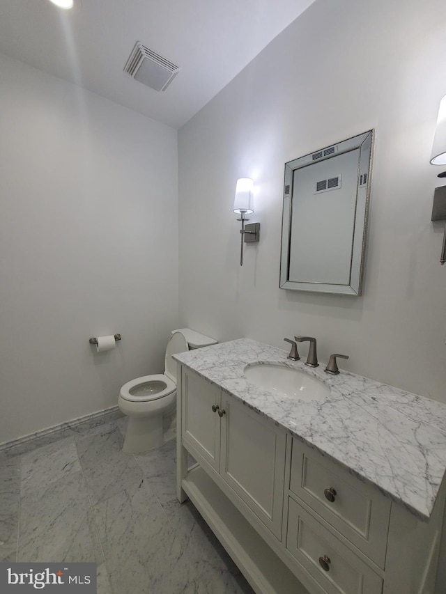 bathroom featuring toilet and vanity