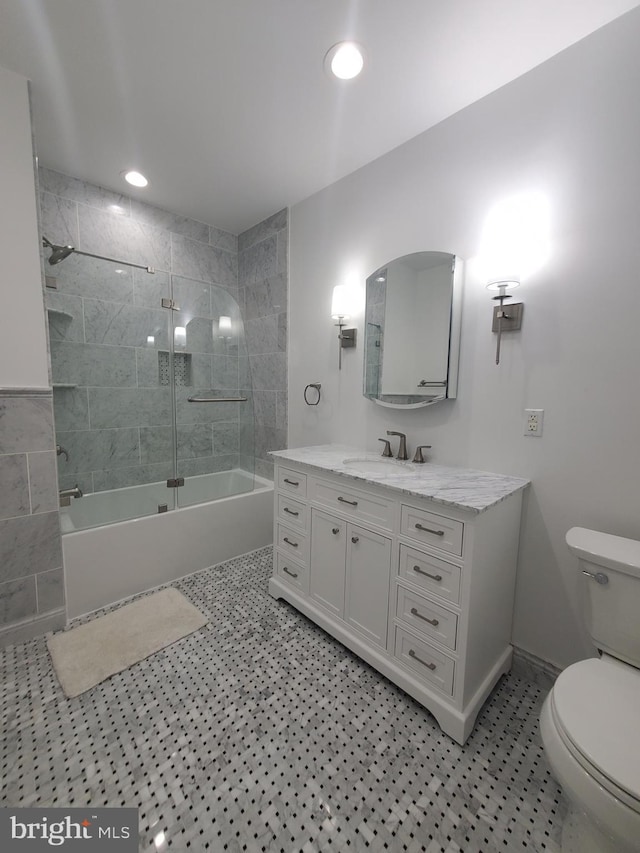 full bathroom featuring toilet, tile patterned floors, combined bath / shower with glass door, and vanity