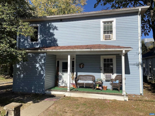 view of front of home featuring cooling unit and covered porch