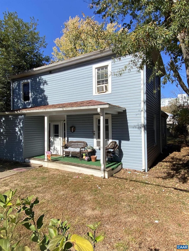 front of property with cooling unit and covered porch