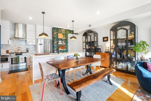 dining area featuring light wood-type flooring