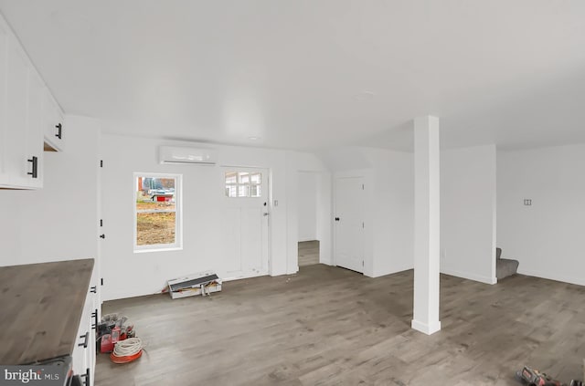 entryway featuring an AC wall unit and hardwood / wood-style floors