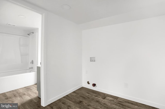 clothes washing area with dark hardwood / wood-style flooring