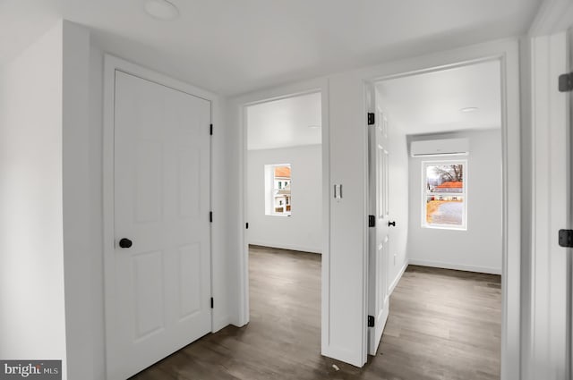 corridor featuring an AC wall unit and dark hardwood / wood-style flooring