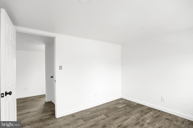 empty room featuring dark hardwood / wood-style flooring