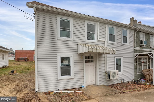 view of front of home with ac unit and cooling unit