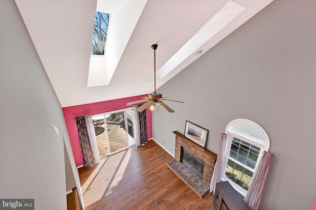 3701 Green Ash Ct, Beltsville, MD 20705 - living room with hardwood / wood-style flooring, a skylight, high vaulted ceiling, ceiling fan, and a brick fireplace