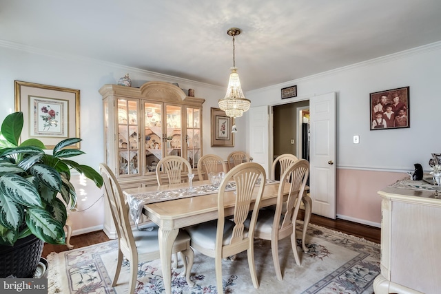 dining space with hardwood / wood-style floors and ornamental molding