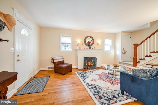 living room with light hardwood / wood-style flooring and a wealth of natural light