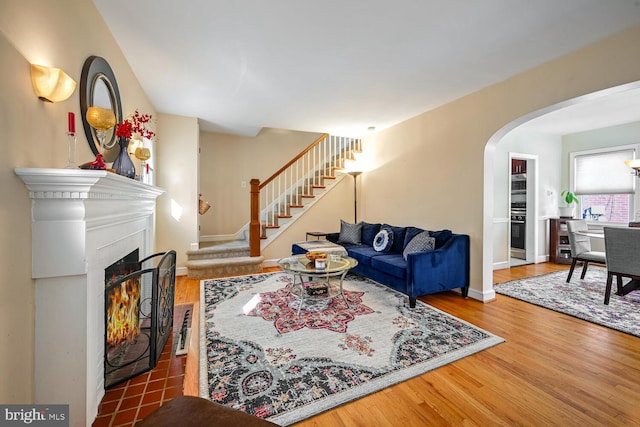 living room featuring hardwood / wood-style flooring and a tiled fireplace