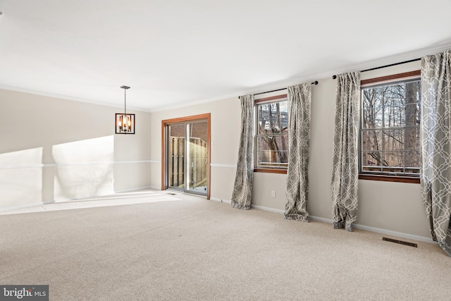 spare room featuring light colored carpet, a notable chandelier, and ornamental molding