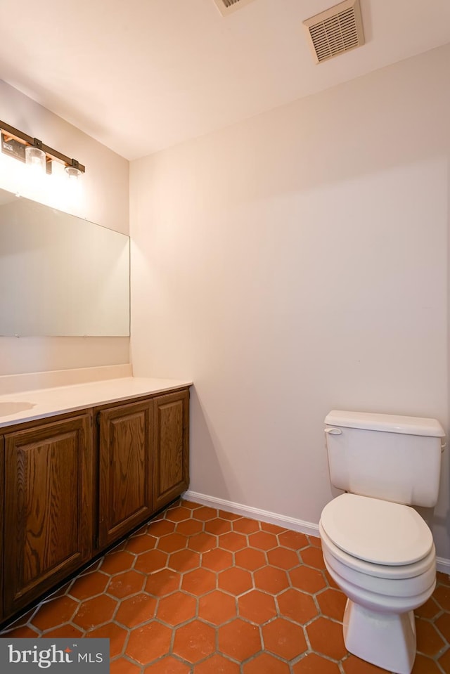 bathroom with tile patterned flooring, vanity, and toilet