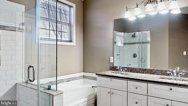 bathroom with vanity and shower with separate bathtub