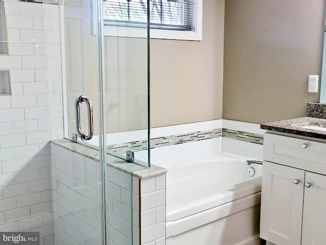 bathroom featuring vanity and separate shower and tub