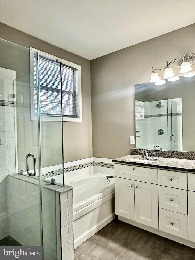 bathroom with tile patterned floors, vanity, and plus walk in shower