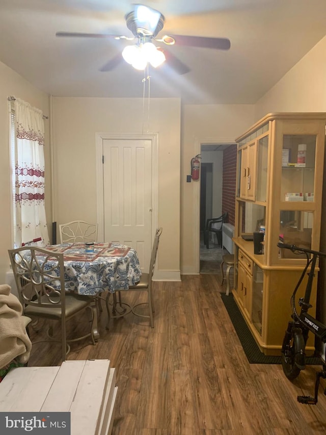 dining area with dark hardwood / wood-style floors and ceiling fan