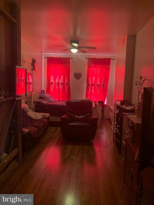 living room with ceiling fan and dark hardwood / wood-style floors