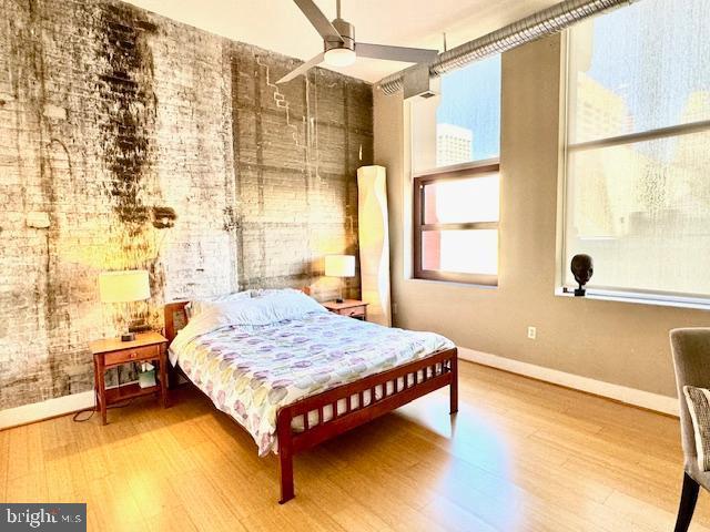 bedroom featuring ceiling fan and hardwood / wood-style flooring