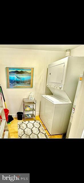 laundry area with stacked washer / drying machine