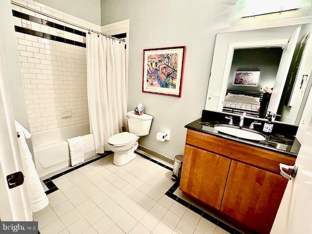 full bathroom featuring tile patterned floors, vanity, shower / bath combination with curtain, and toilet