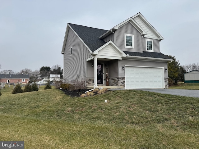 view of front of home with a front yard and a garage