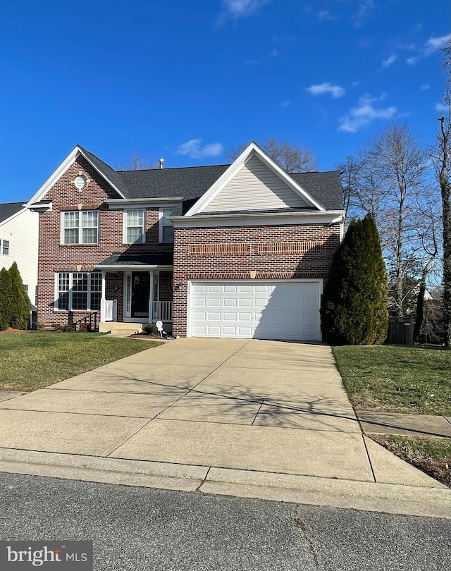 view of front of home featuring a front yard, a porch, and a garage