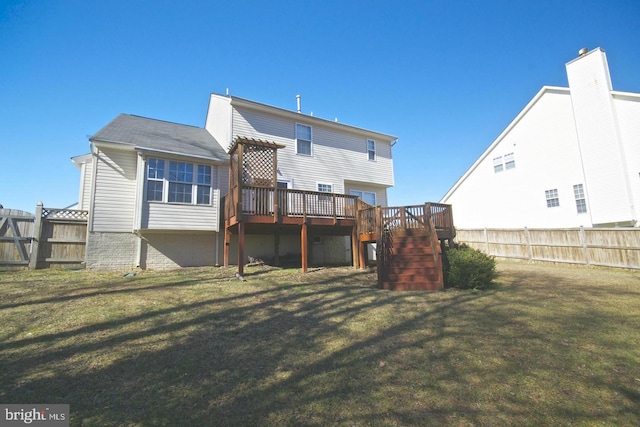 rear view of property featuring a lawn and a wooden deck