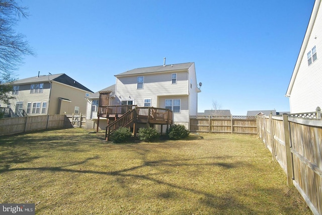 rear view of property with a yard and a deck