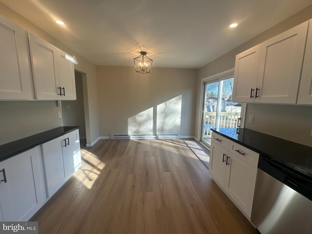 kitchen with white cabinetry, light hardwood / wood-style flooring, stainless steel dishwasher, and an inviting chandelier