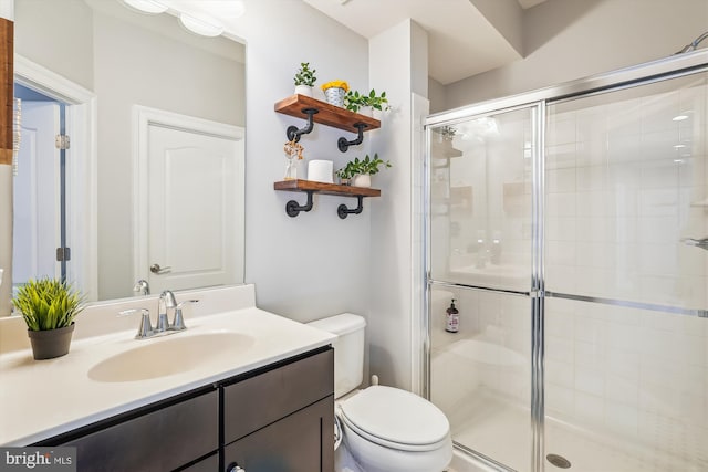 bathroom featuring walk in shower, vanity, and toilet