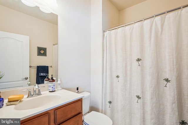 bathroom featuring toilet and vanity