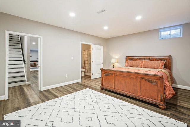 bedroom with dark hardwood / wood-style flooring and ensuite bathroom