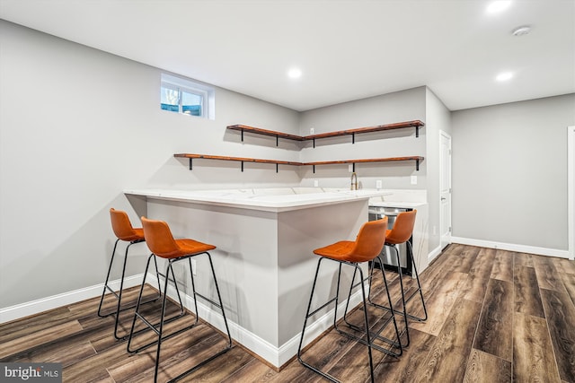 bar with dark wood-type flooring