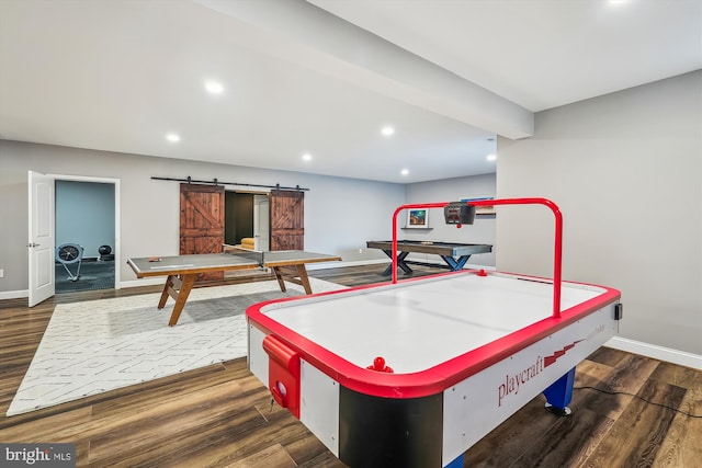 rec room featuring dark hardwood / wood-style flooring and a barn door