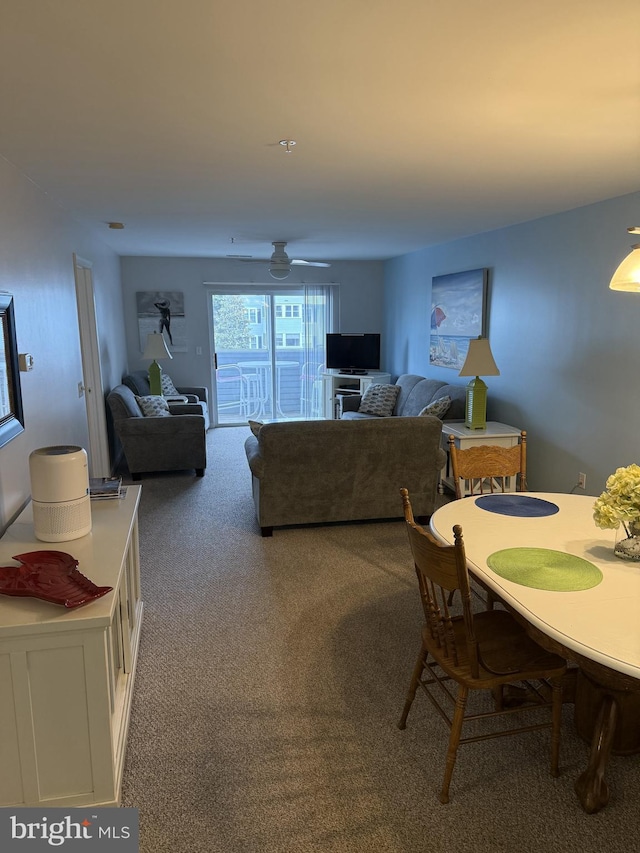 carpeted dining area featuring ceiling fan