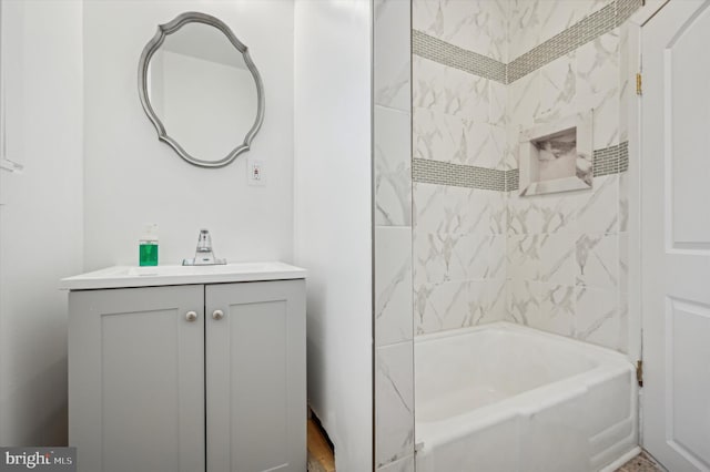 bathroom with vanity and tiled shower / bath combo