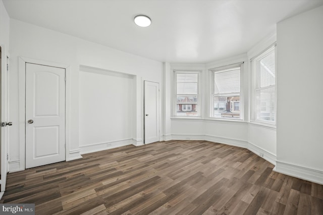 empty room featuring dark hardwood / wood-style flooring