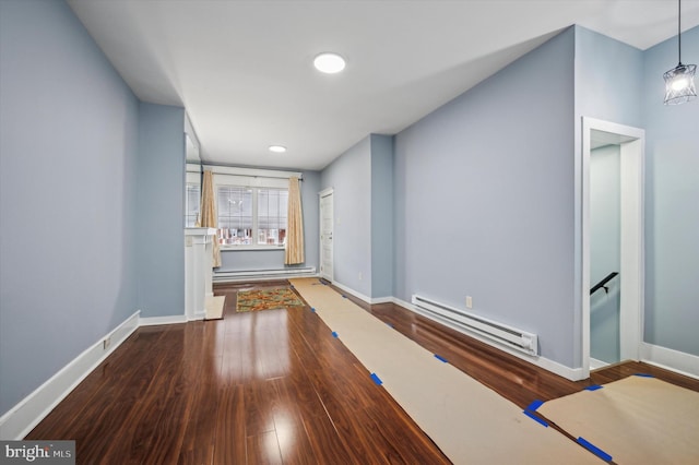 hall with hardwood / wood-style floors and baseboard heating