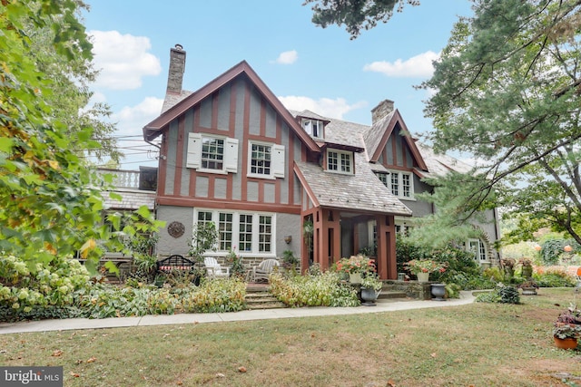 rear view of house with a yard