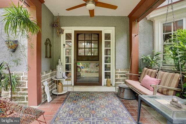 view of exterior entry featuring ceiling fan