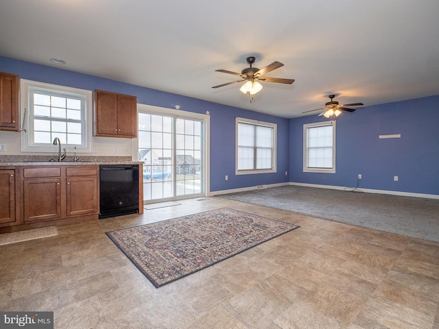 kitchen featuring sink, black dishwasher, and ceiling fan