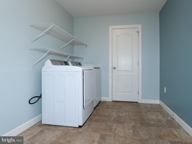 clothes washing area with washer and clothes dryer