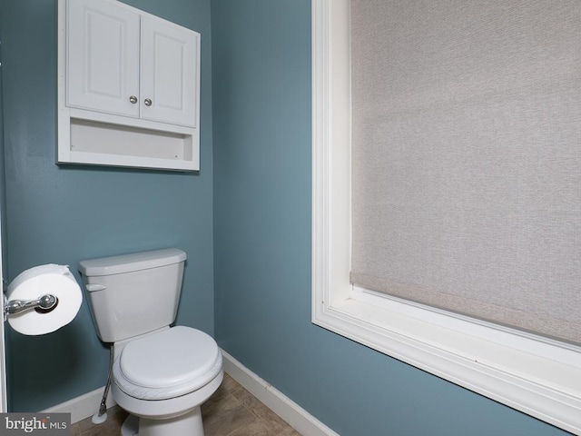 bathroom featuring toilet and tile patterned flooring