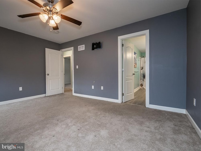 unfurnished bedroom with ceiling fan, ensuite bathroom, and carpet flooring