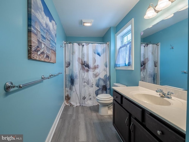 bathroom with walk in shower, toilet, vanity, and wood-type flooring