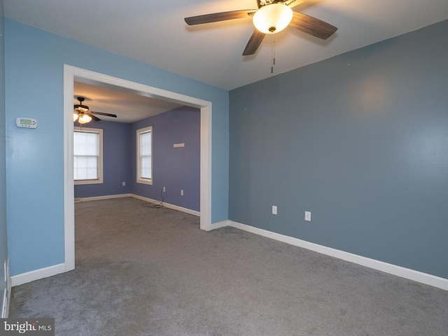 empty room with ceiling fan and carpet