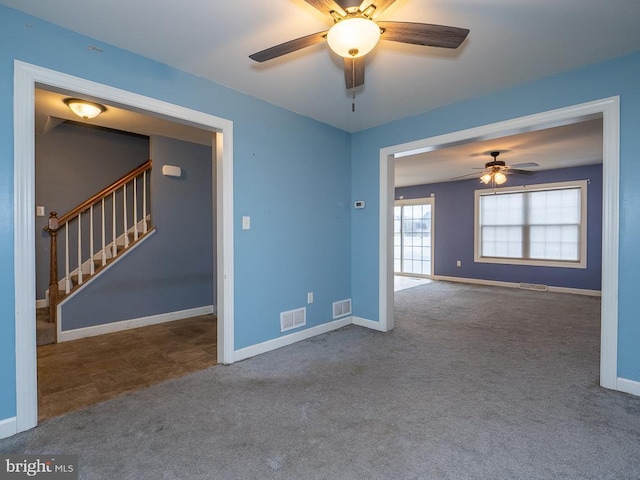 spare room with carpet floors and ceiling fan